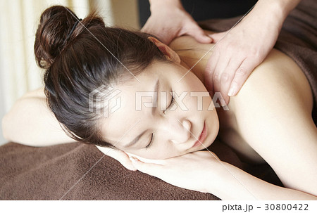 Beautiful woman with closed eyes is getting a massage in the spa. 30800422