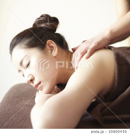 A woman is relaxing while the therapist is massaging. A woman is relaxing while the therapist is massaging. 30800430