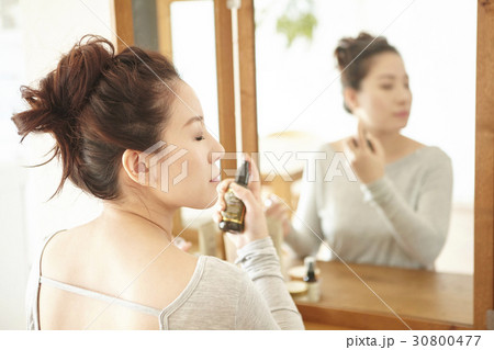 A photo of beautiful woman with mineral water spray. 30800477