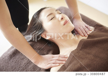 a woman gets a shoulder massage in spa. a woman gets a shoulder massage in spa. 30800487