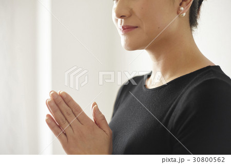 a happy woman is clasping hands. 30800562
