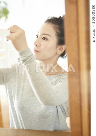 an image of a woman lifting up and looking at something in a mirror an image of a woman lifting up and looking at something in a mirror 30800580