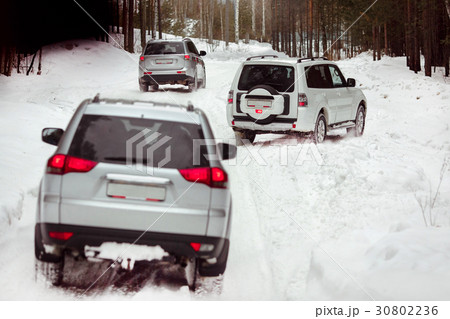 Three SUVs in the woods in winter in the rally 30802236