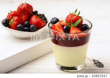 Panna cotta with berry jelly and berries. 30807837