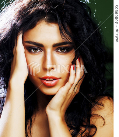 young smiling brunette woman on green background 30809905