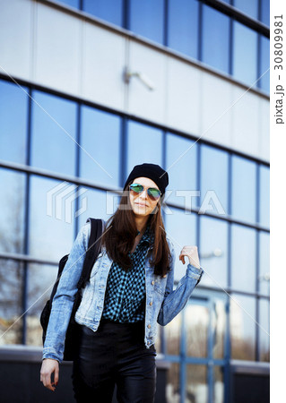 young pretty girl near business building walking 30809981