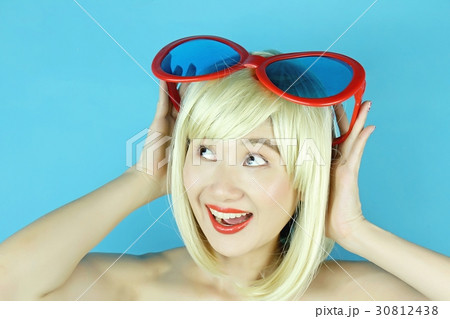 Playful girl with funny glasses. 30812438