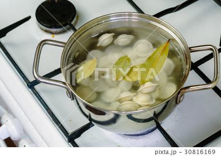 dumplings boiled in a pot. 30816169