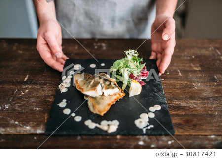 Chef decorate with vegetables dish of fried fish Chef decorate with vegetables dish of fried fish 30817421