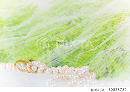 necklace of pearls, wedding rings and bouquet  30823782