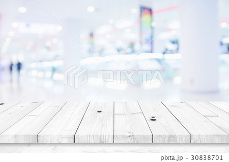 Wood table with blur shopping mall background. Wood table with blur shopping mall background. 30838701