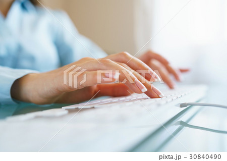 Woman office worker typing on the keyboard 30840490