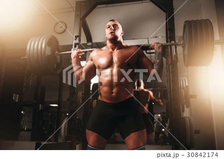 Weightlifter exercise with barbell in sport gym Weightlifter exercise with barbell in sport gym 30842174