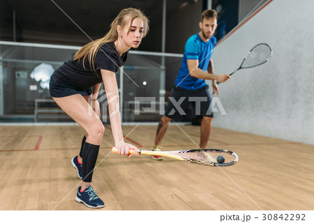 Couple with squash rackets, indoor training club 30842292