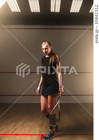 Woman with squash racket, indoor training club Woman with squash racket, indoor training club 30842312
