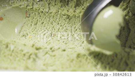 pistachio ice cream being scooped close up pistachio ice cream being scooped close up 30842613