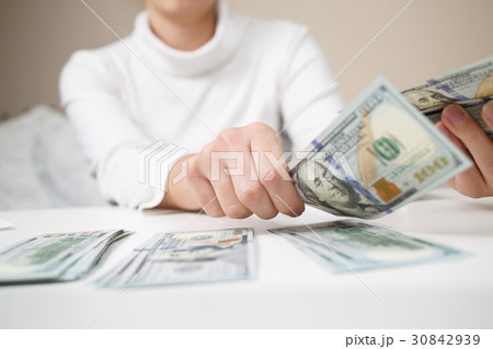 Close up of woman with calculator counting money 30842939