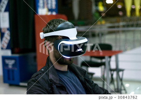 Brutal young man in VR headset who enjoyng game 30843762