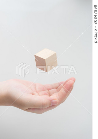 Abstract wooden cube float on girl's hand Abstract wooden cube float on girl's hand 30847899