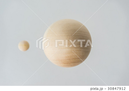 Floating wooden ball on grey background 30847912