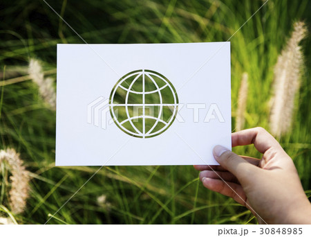 Hand Hold Globe Paper Carving with Grass Background 30848985