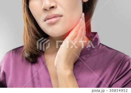 Woman with a sore throat holding her neck Woman with a sore throat holding her neck 30854952