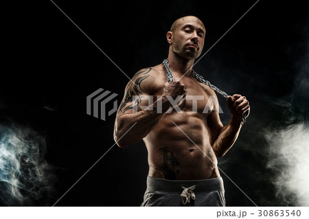 Strong bald man with metal chain Strong bald man with metal chain 30863540