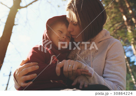 Young mother hugging her little son 30864224