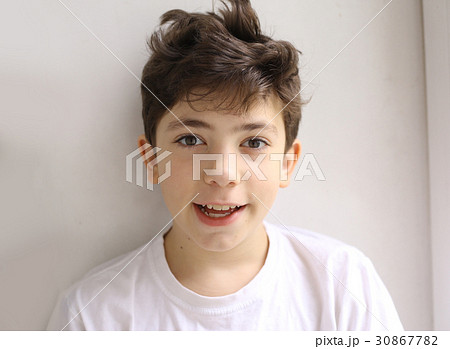 Image of Teen smiling happy boy with shaggy hair close up photo