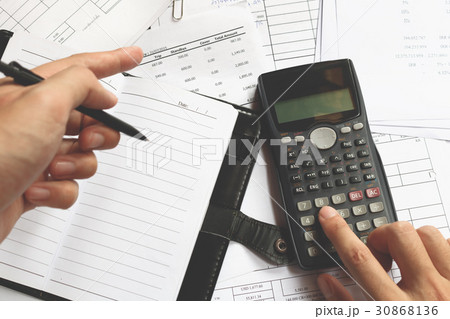 Business people counting on calculator Business people counting on calculator 30868136