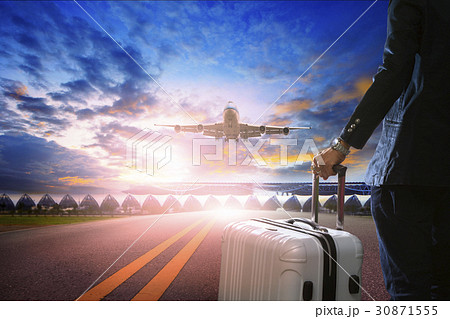 man and traveling lugage standing in airport 30871555