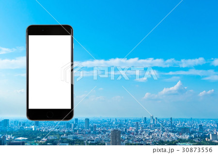スマホ　携帯電話　スマートフォン　都市風景　東京　不動産イメージ 30873556