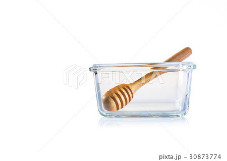 clear glass bowl with honey dipper on white clear glass bowl with honey dipper on white 30873774