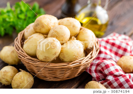 Raw potato in basket on wooden table closeup Raw potato in basket on wooden table closeup 30874194