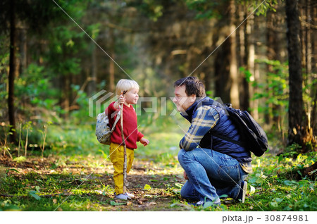 Father and his son walking during the hiking activities in forest Father and his son walking during the hiking activities in forest 30874981