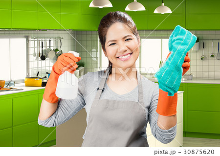 asian housekeeper holding spray bottle and rag asian housekeeper holding spray bottle and rag 30875620