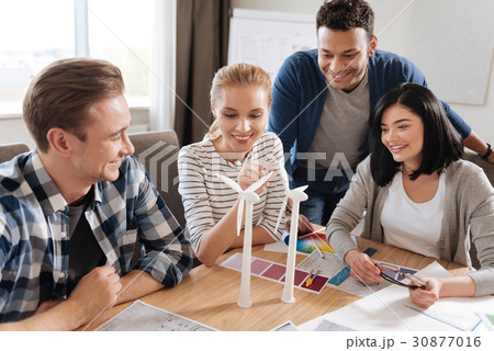 Beautiful curious woman looking at the windmill Beautiful curious woman looking at the windmill 30877016