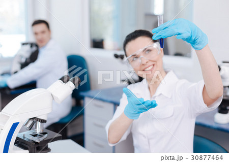 Attractive researcher presenting new assay reagent Attractive researcher presenting new assay reagent 30877464