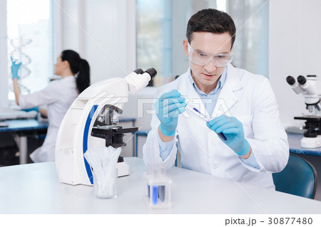 Serious man doing reagent analysis Serious man doing reagent analysis 30877480
