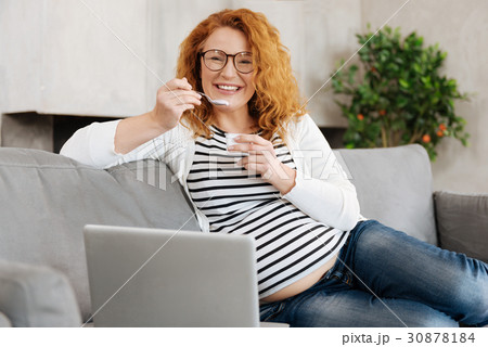 Thrice happy pregnant woman eating yoghurt 30878184