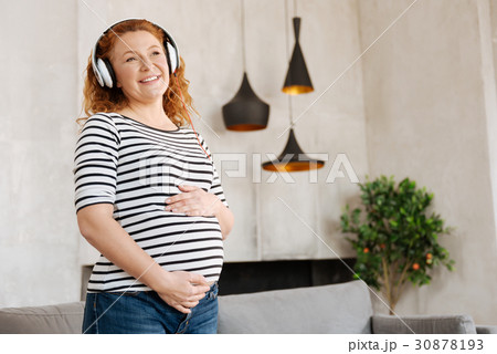 Excited pregnant woman listening to music Excited pregnant woman listening to music 30878193
