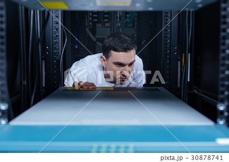 Serious male engineer checking the rack server 30878741
