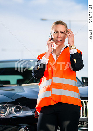 Woman with car breakdown calling towing company Woman with car breakdown calling towing company 30879185