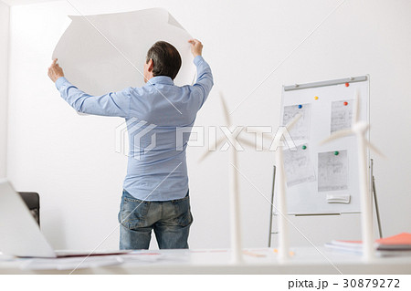 Professional engineer holding blueprint Professional engineer holding blueprint 30879272