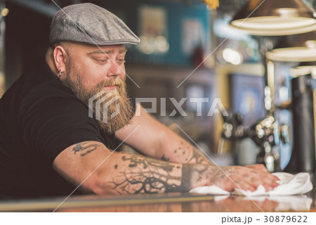 Serious bearded guy working meditatively Serious bearded guy working meditatively 30879622