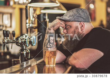 Lonely adult guy sitting in pub thoughtfully 30879678