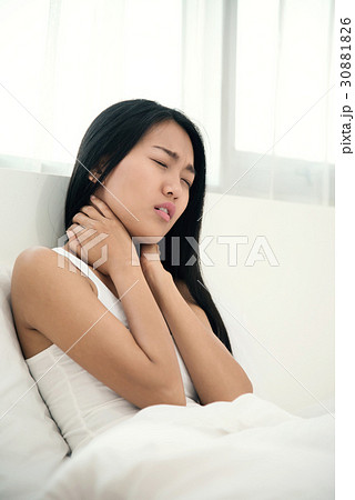 Asian woman having neck pain on her bed. Asian woman having neck pain on her bed. 30881826
