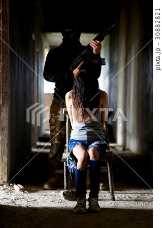 Man in balaclava threatening with gun to woman 30882821