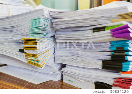 Pile of unfinished documents on office desk Pile of unfinished documents on office desk 30884120