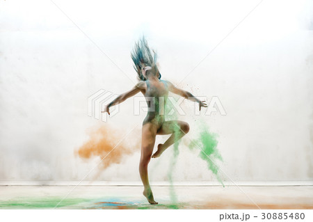 Sexy girl in a cloud of color dust studio portrait 30885480